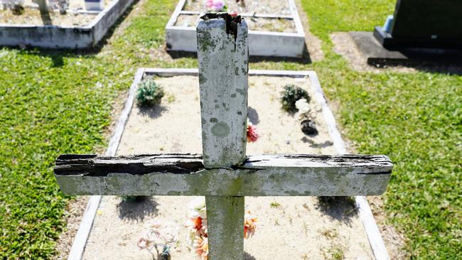 A wooden cross on a gravesite at the Gordonvale Cemetery which has rotted and decayed in the harsh FNQ weather. Picture: Brendan Radke