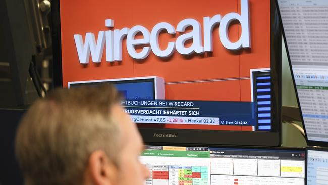 A stockbroker sits in front of a screen with news about the payment service provider Wirecard at the Frankfurt Stock Exchange. Picture: AP