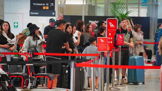 Qantas passengers queue for check-in and bag drop. Picture: NewsWire/Luis Enrique Ascui.