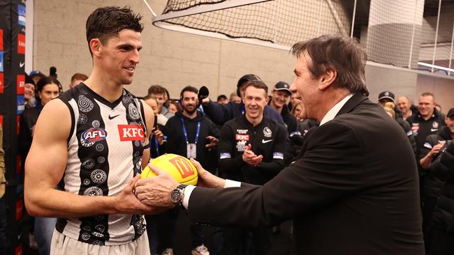 Collingwood president Jeff Browne handing Scott Pendlebury the match ball after he broke the disposal record in round 17. Picture: Michael Klein.