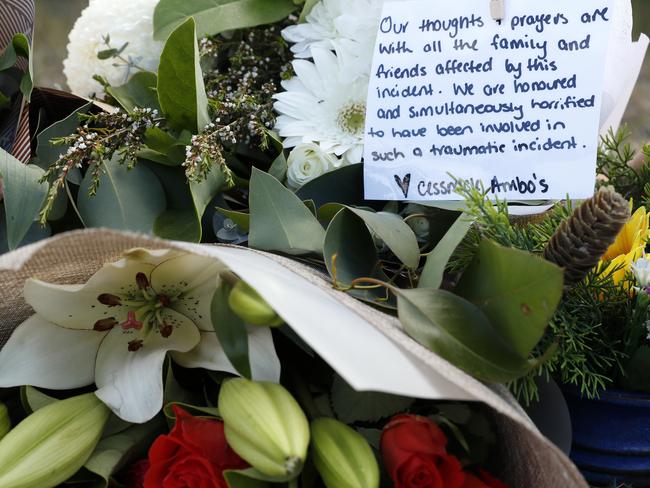 Floral tributes, including one from the Cessnock ambos, left near the scene of the horrific bus crash, which killed 10 people and injured 25 others at Greta in the Hunter wine country. Picture: Jonathan Ng