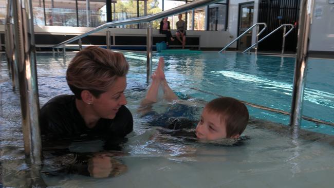 Exercise physiologist Nic Grose and Tyler Shields enjoy their first session in Dubbo's new hydrotherapy pool. Picture: Ryan Young