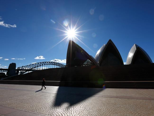 A person walks in front of the Sydney Opera House in a virtually empty Sydney CBD on the weekend. Picture: Damian Shaw