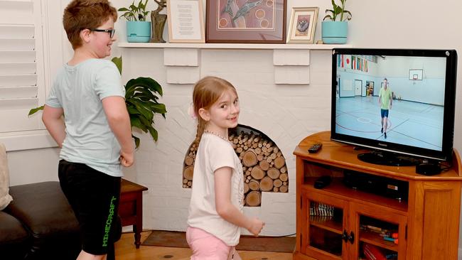 Samuel and Lucy Heath try an online physical education package. Picture: NCA NewsWire / Naomi Jellicoe