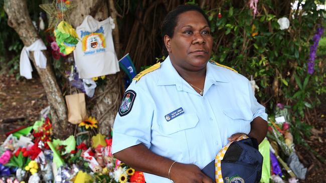 Police Liason Officer Kathy Lowah in front of a temporary memorial in Murray Street park for eight children who were stabbed to death in a nearby house. Picture: Brendan Radke.