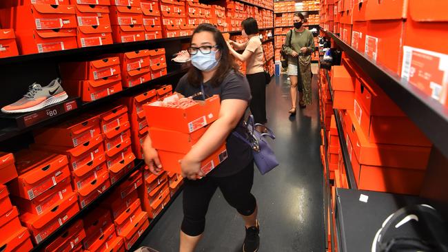 Large queues led into the Nike and Adidas stores at DFO South Wharf in Victoria on Black Friday. Picture: Tony Gough