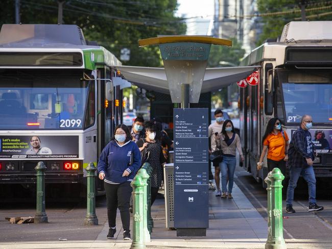 MELBOURNE, AUSTRALIA - NewsWire Photos NOVEMBER 16 2020:  More "back-to-work" life is visible in the CBD, though still far from normal commuter and pedestrian traffic due to the DHHS "Work from home if you can" directive still in place in Melbourne. Slightly more Tram commuters visible as they disembark on Elizabeth Street.  Picture: NCA NewsWire / Sarah Matray