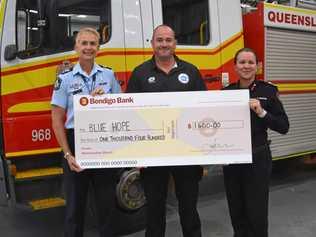 SIGNED, SEALED, DELIVERED: Senior Sergeant Kim Cavell and QFES Acting Assistant Commissioner Michelle Young present Andrew Ayres with a $1400 cheque. Picture: Eden Boyd