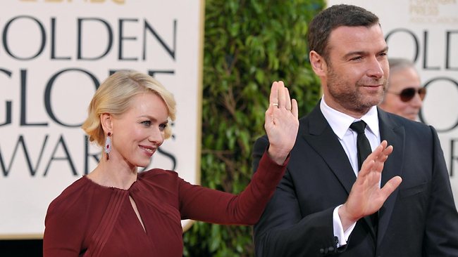 Naomi Watts, who is nominated for her work in The Impossible, and partner Liev Schreiber wave to fans as they arrive at the Golden Globe Awards.