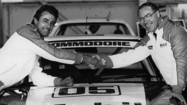 Allan Moffat (R) and Peter Brock shaking hands on a groundbreaking deal.