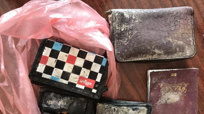 Recovered personal items from MH17 Plane Crash site. Some of the items included two Dutch passports, a Samsung tablet and two wallets containing bank cards and identification. Picture: Supplied