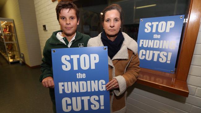 Anissa Symington and her son Ben protest against planned funding cuts to some Catholic schools.