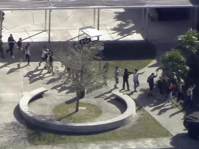 In this frame grab from video provided by WPLG-TV, students from the Marjory Stoneman Douglas High School evacuate following the shooting. Picture: WPLG-TV via AP