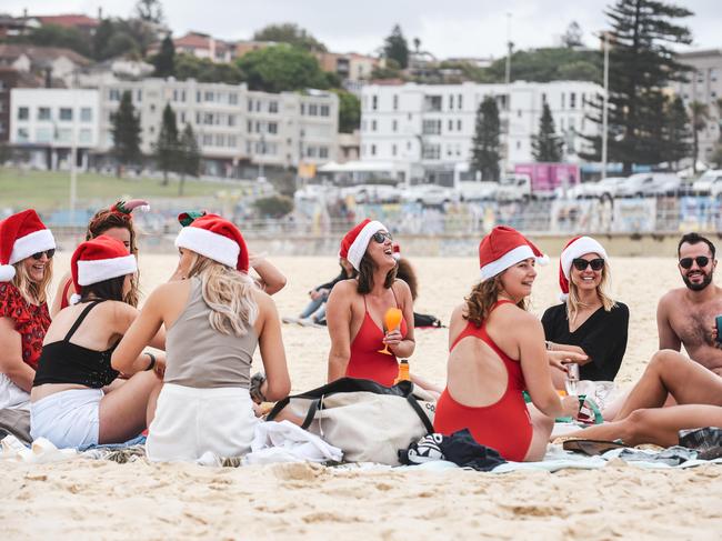 A group wearing Santa Hats are seen on Bondi Beach. Picture: NCA NewsWire/Flavio Brancaleone