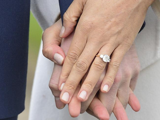 Meghan Markle wears her engagement ring as she poses with Britain's Prince Harry for the media in the grounds of Kensington Palace in London. Picture: AP.