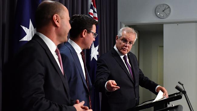 Treasurer Josh Frydenberg, left, Emergency minister David Littleproud and Prime Minister Scott Morrison unveil the emergency relief. Picture: Sam Mooy/Getty Images