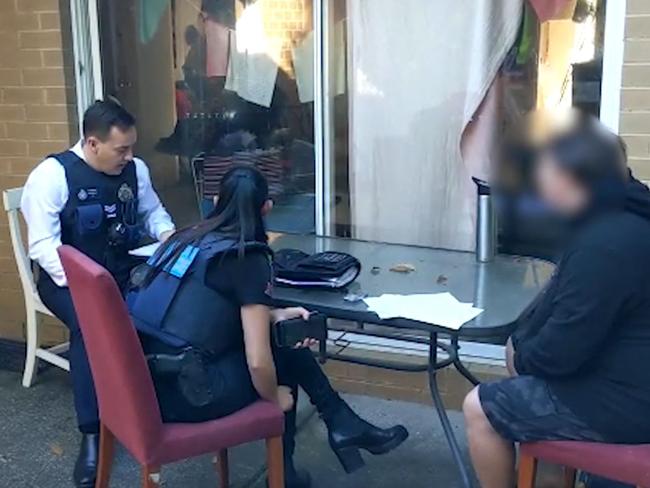 AFP officers undertake a search warrant after arresting a man under Operation Arkstone. Picture: AFP.