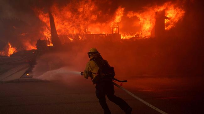 A firefighter battles flames from the Palisades Fire. Picture: AFP