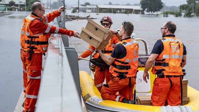 SES volunteers delivering medical supplies to take to local chemists which are isolated from the flood waters in Windsor. Picture: Darren Leigh Roberts