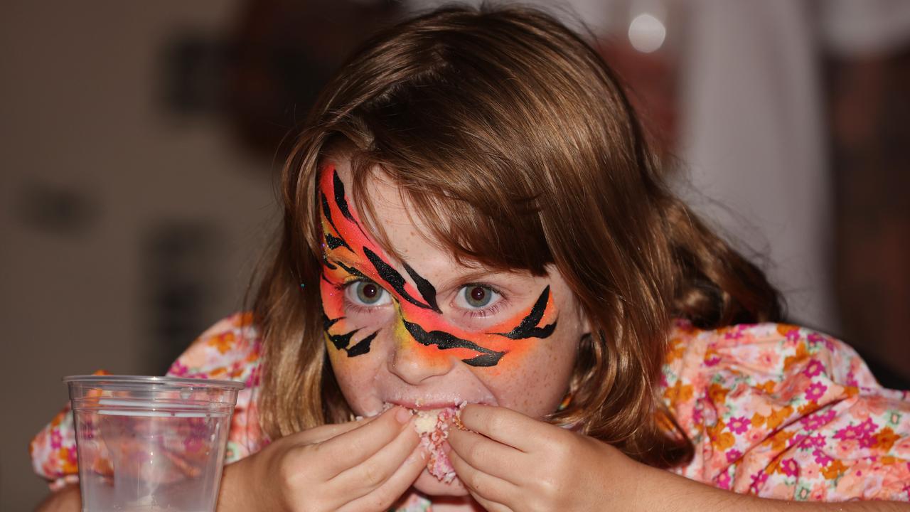 Daisy Taylor,7, goes hard at the Lamington eating competition on Australia Day at the Banana Bender Pub on the Sunshine Coast. Picture: Lachie Millard