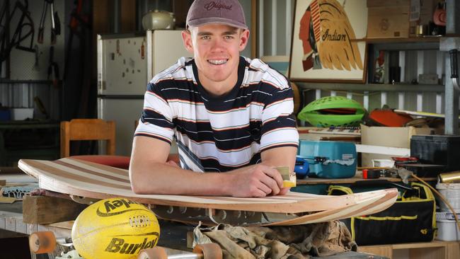 Top AFL draft prospect Jez McLennan at work on his school project surfboard, at home in the Barossa Valley. Picture: AAP Image/Dean Martin