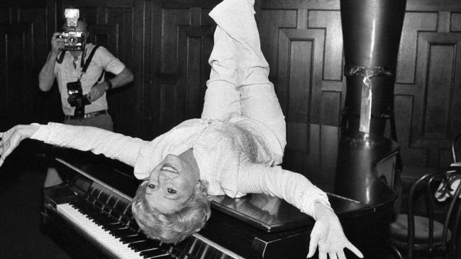 Reynolds likes on a piano while promoting a Broadway revival of The Unsinkable Molly Brown in New York in 1982. Picture: AP Photo/Marty Lederhandler, File