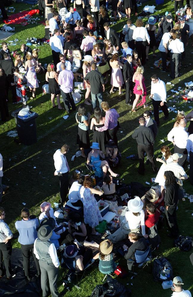 Punters make the most of new friendships and the afternoon sun after the last race at Flemington.