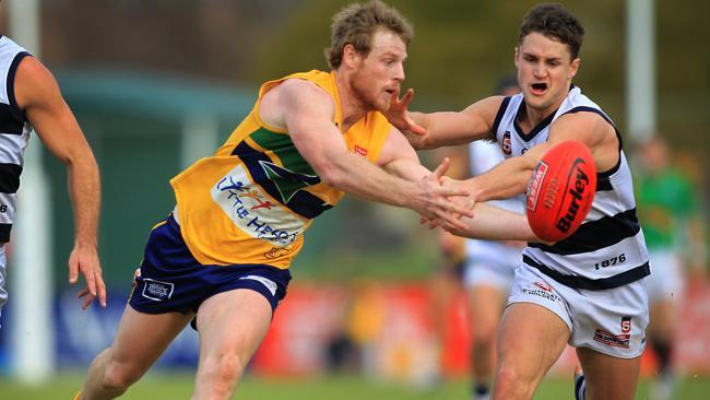 The Eagles' Chris Kane tussles with South's Xavier Gotch during the match at Woodville. 