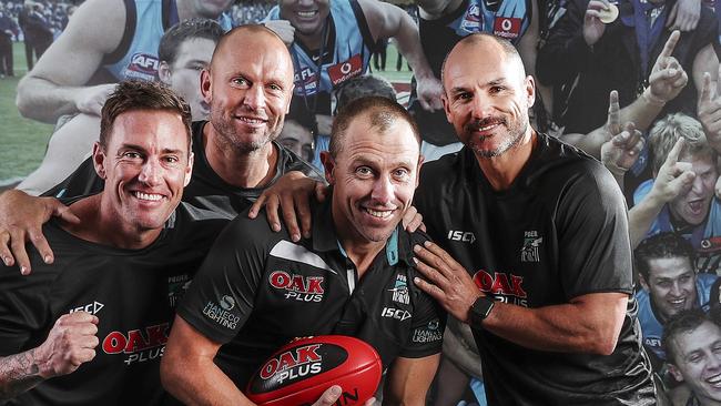 Michael Wilson, holding the ball, has been let go by Port Adelaide from his physio role at the club because of the COVID-19 pandemic and its impacts on club finances. Picture SARAH REED