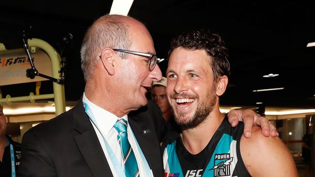 David Koch, chairman of the Power (left) in happier times with skipper Travis Boak in China. Picture: Michael Willson/AFL Media/Getty Images.