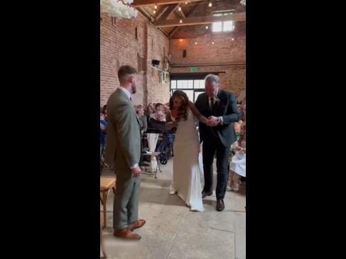 Woman in wheelchair walks down the aisle