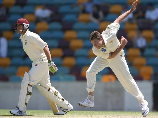 Adam Griffith bowling against Queensland during the 2006-07 season as the Bulls’ Matthew Hayden looks on. Picture: PETER WALLIS