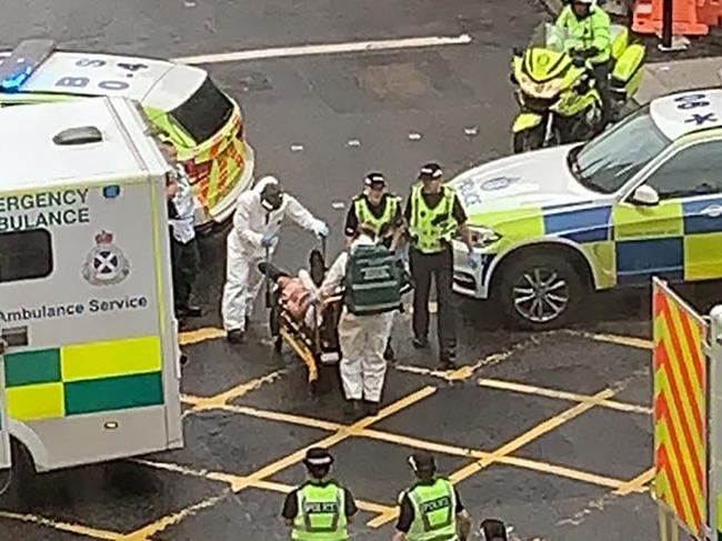 Emergency services take a victim away on a stretcher in Glasgow city centre. Picture: AFP PHOTO /Milroy1717.