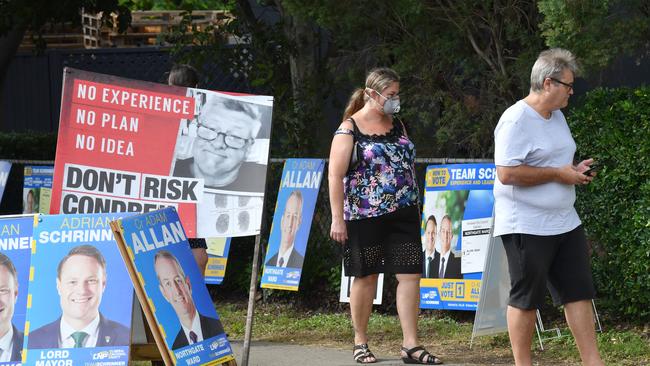 A voter in a mask is seen turning out to vote at a pre-polling booth in Virginia, on Brisbane’s northside, on Friday. Picture: AAP Image/Darren England