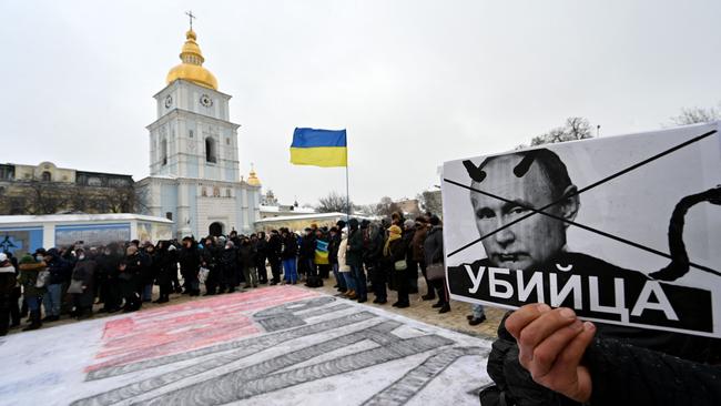 A demonstrator holds a placard depicting Russian president Vladimir Putin above the word for “killer” during an action dubbed #SayNOtoPutin in Kiev earlier this month. Picture AFP