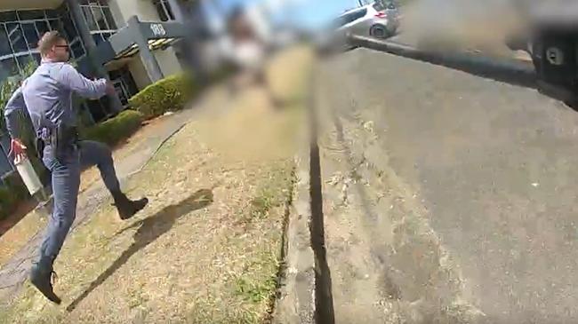 A Tactical Crime Squad officer in full flight chasing down an alleged car thief on Mulgrave Road. Picture: Queensland Police