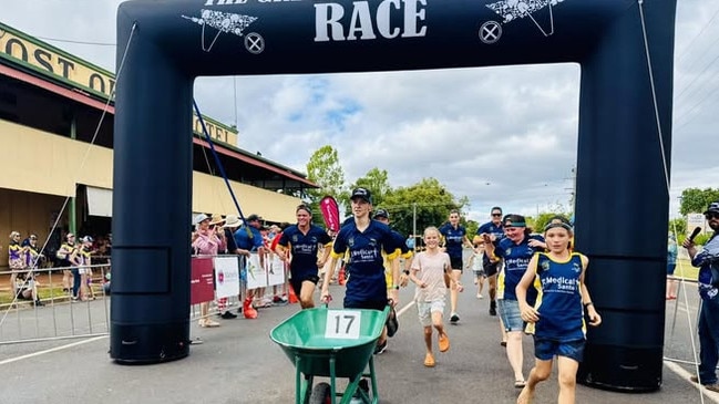 The last team arrives at the finish of the Great Wheelbarrow Race. Photo: Facebook