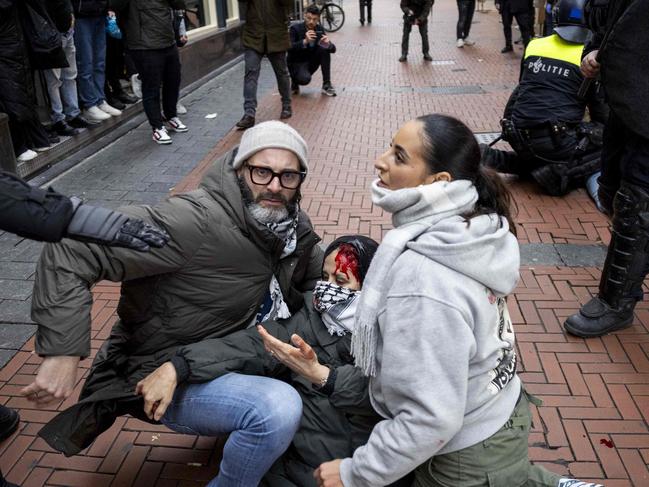 Demonstrators help a bloodied pro-Palestinian during protests in Amsterdam. Picture: AFP