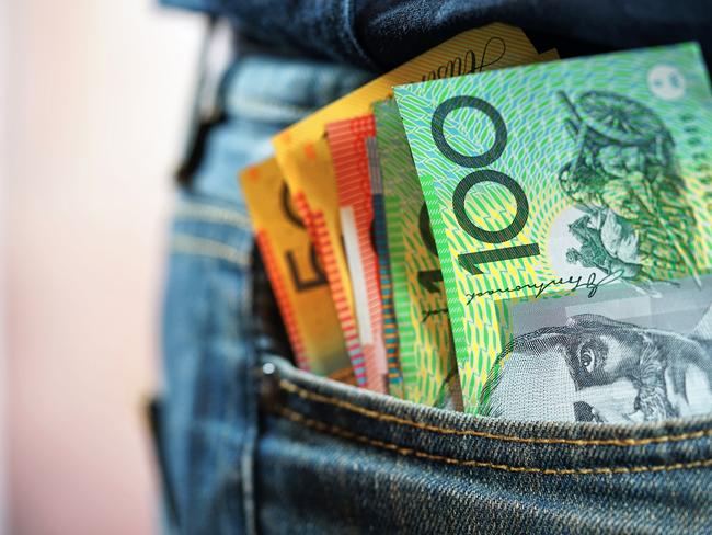 Australian cash money in mans jeans pocket, close up.