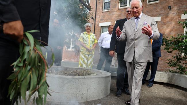 King Charles III takes part in a smoking ceremony during a visit to the National Centre for Indigenous Excellence in Sydney on Tuesday. Picture: NewsWire / POOL / Toby Melville