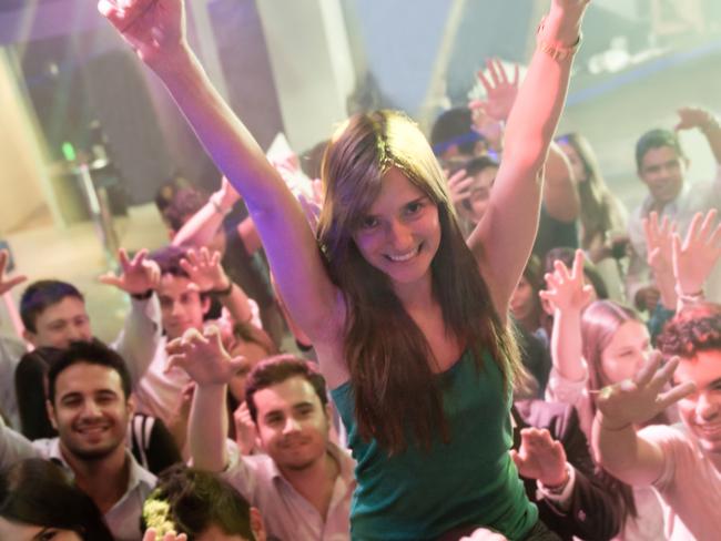 Happy woman enjoying the party at a nightclub