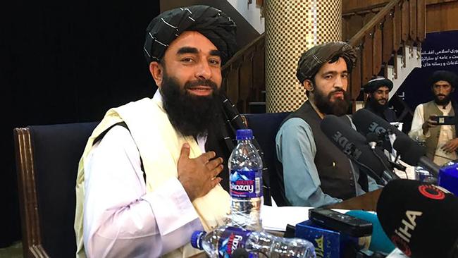 Taliban spokesman Zabihullah Mujahid, left, at the press conference in Kabul. Picture: AFP