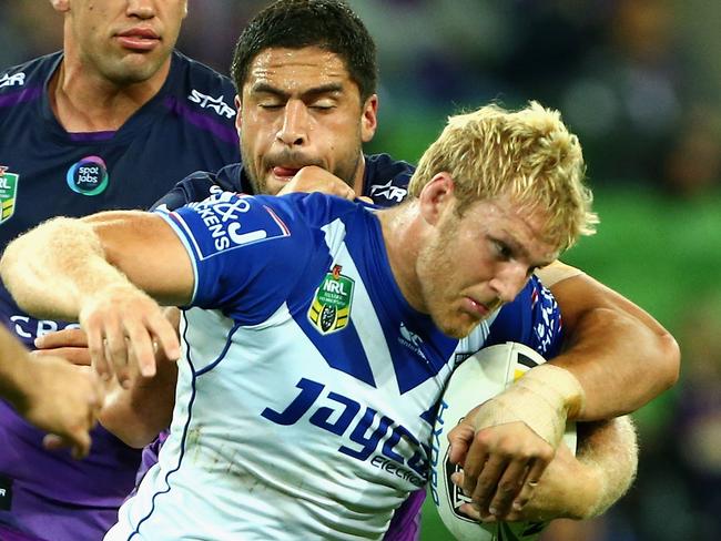 Aiden Tolman is tackled by Jesse Bromwich.