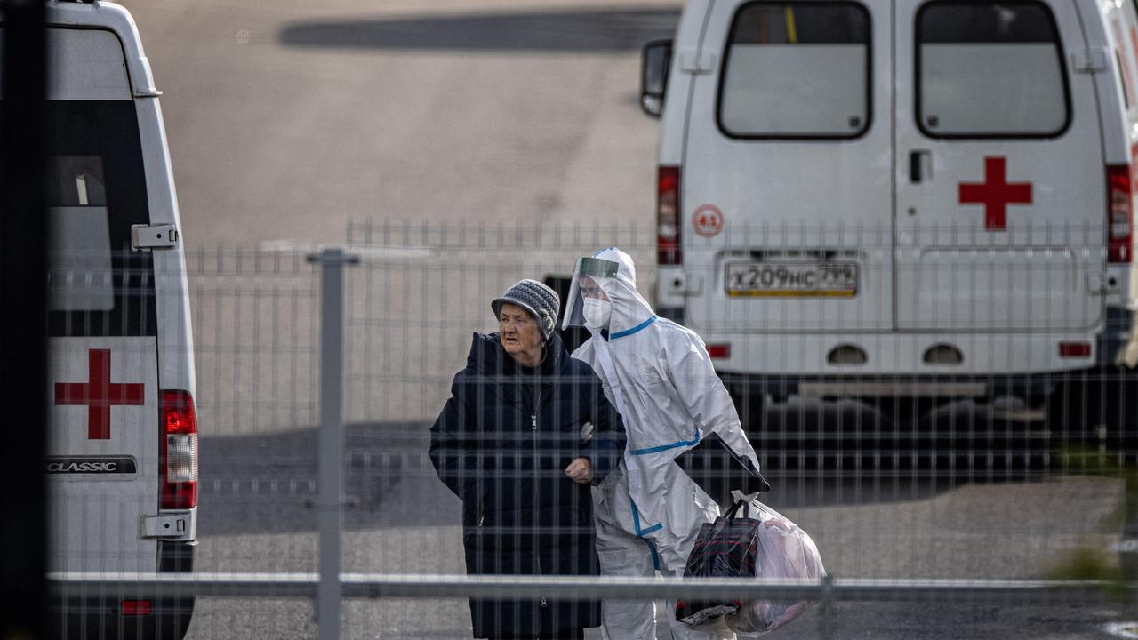 A medical staff member accompanies a patient at the Covid-19 infected patients section at the Kommunarka Hospital outside Moscow. Picture: Dimitar Dilkoff / AFP