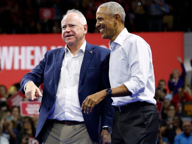 Former US President Barack Obama (R) smiles next to Minnesota Governor and Democratic vice presidential candidate Tim Walz after speaking during a campaign rally in support of Vice President and Democratic presidential candidate Kamala Harris, at Alliant Center in Madison, Wisconsin, on October 22, 2024. (Photo by KAMIL KRZACZYNSKI / AFP)