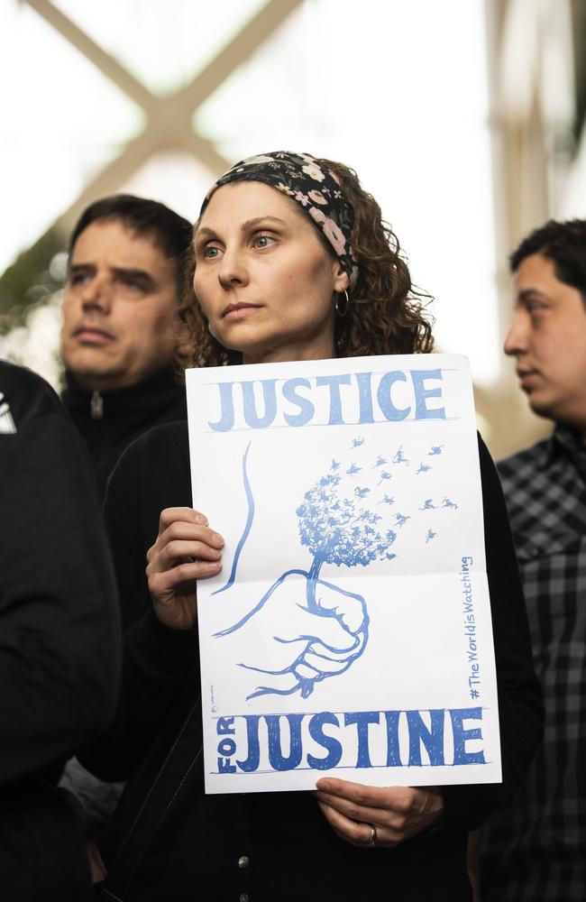 Jenelle Masterson holds a sign reading Justice for Justine during a press conference on April 1. Picture: AFP