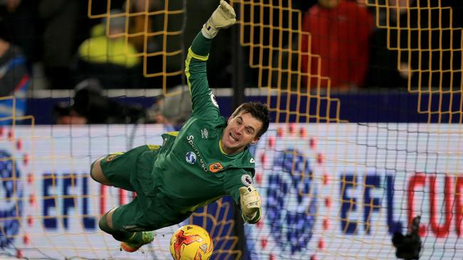 Hull City goalkeeper Eldin Jakupovic saves Newcastle United's Jonjo Shelvey's shot.