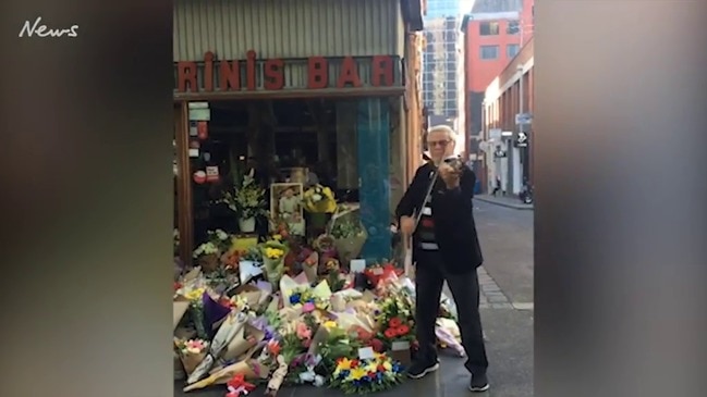 Violinist plays a tribute outside Pellegrini's