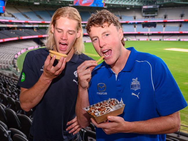 Carlton young gun Tom De Koning and North Melbourne's Nick Larkey tuck into food at Marvel Stadium. Picture: Jordan Sacchetta