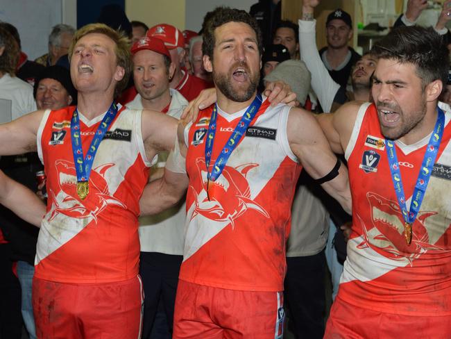 Nepean football league Grand Final: Sorrento v Frankston at Frankston Park. The Sharks went into the grand final as favourites and delivered another flag with a comfortable win over the Bombers. (L-R) Aaron Paxton, Troy Schwarze and Chris Dawes belt out the song. Picture: AAP/ Chris Eastman